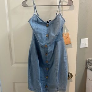 Brand new denim dress with button details. Size large. New with tags.